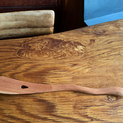 wooden martini mixer with wavy handle on wood table