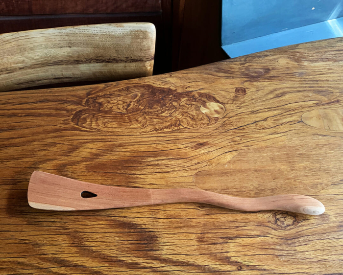 wooden martini mixer with wavy handle on wood table