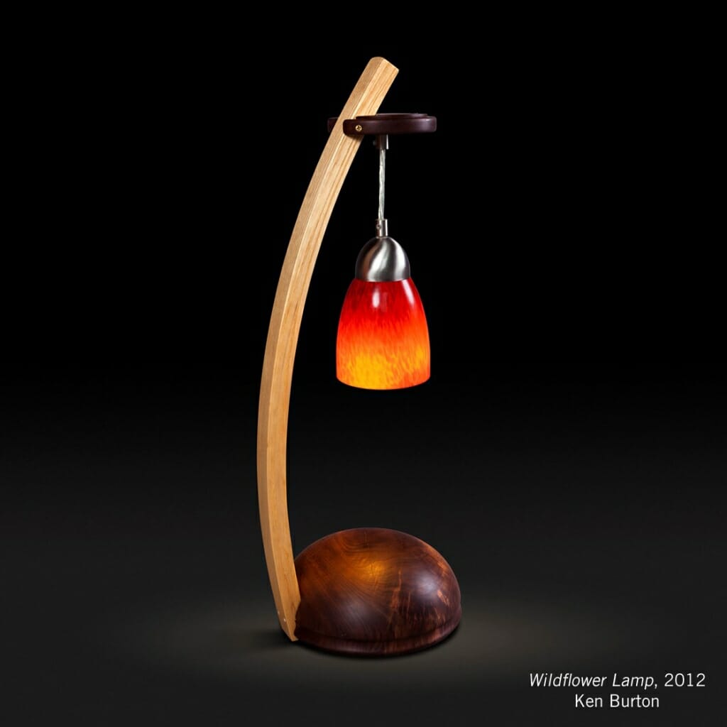 Burton labeled lamp with rounded wood base, curved wood arm and hanging glass shade