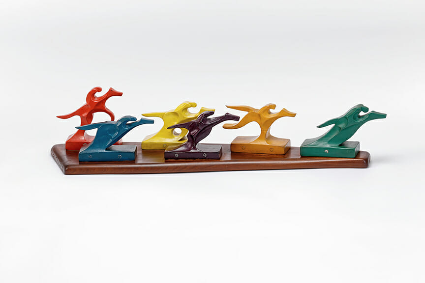 colorful painted wood sculptures of jockeys on horseback