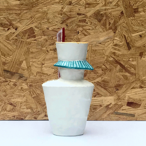 tall white ceramic vessel with turquoise "awning" feature and tall three pane red window. Back side has faint yellow grid on surface