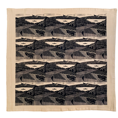 beige tea towel with repeating block print pattern